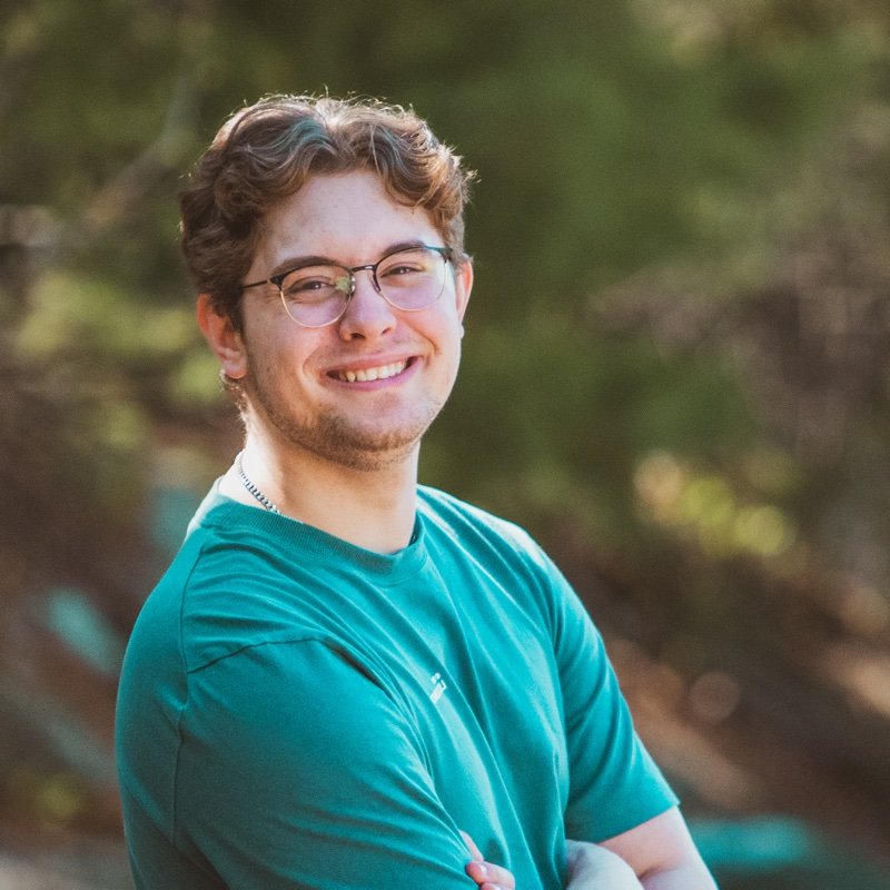 Ben Velkovski smiling outdoors in a teal shirt